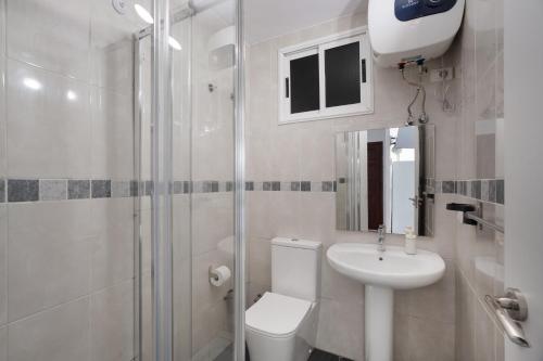 a bathroom with a toilet and a sink and a shower at Loft Guanapay 2 in Los Cristianos