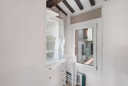 a dressing room with white cabinets and a mirror at Portblanc Front in Arenys de Mar
