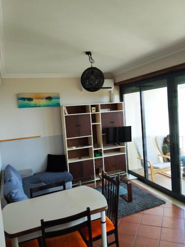 a living room with a couch and a table at Casa Vale do Paraíso in Sesimbra