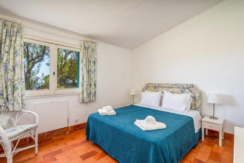 a bedroom with a bed with two towels on it at Ocean Villa Algarve in Alvor