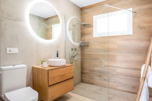 a bathroom with a toilet and a sink and a shower at Casa Robert in Conil de la Frontera