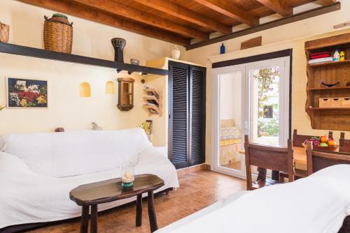 a living room with a white couch and a table at Cala Serena Beach 1 in Felanitx