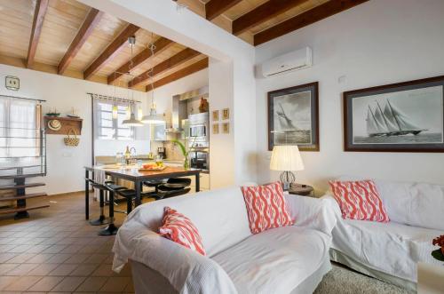 a living room with a white couch and a table at Sa Caseta in Felanitx