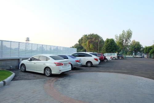 a group of cars parked in a parking lot at Princess River Kwai Hotel in Kanchanaburi