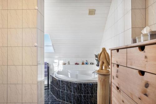a bathroom with a bath tub in a room at fewo-wosink in Bad Krozingen