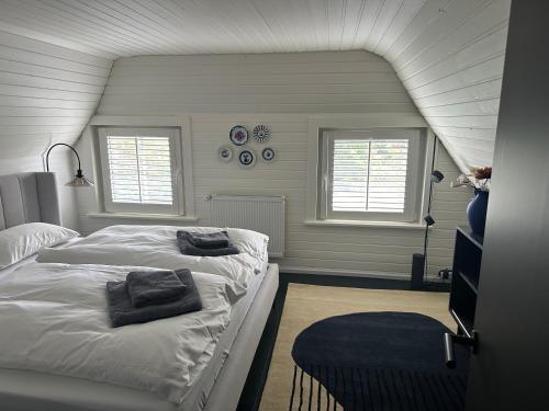 a bedroom with two beds and two windows at Loft32 in Nordstrand
