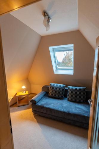 a living room with a couch and a window at Ferienhaus Ferienhof Behnke in Heringsdorf