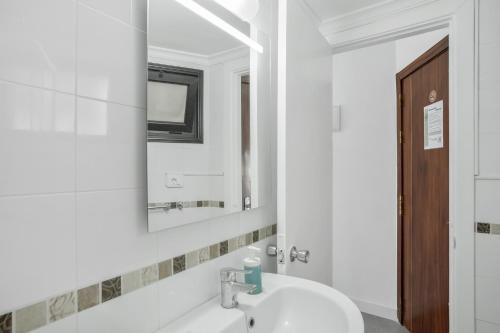 a bathroom with a sink and a mirror at Estudio Yumbo Playa in San Bartolomé