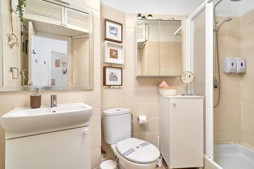a bathroom with a sink toilet and a mirror at Estudio Lighthouse F77 A109 in Torrox Costa
