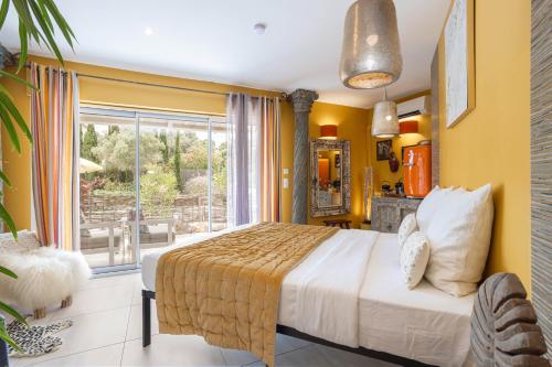 a bedroom with a bed and a large window at Lointaines escapades in Perpignan
