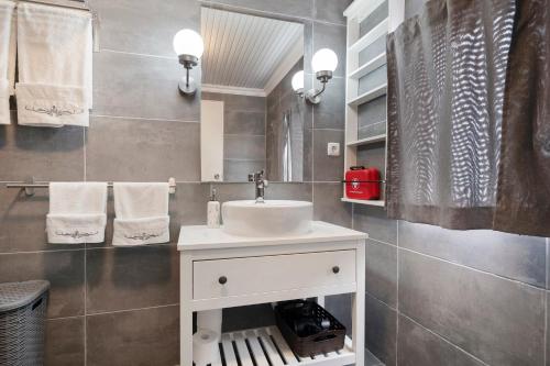 a bathroom with a white sink and a mirror at Casa Branca in Ribeiras