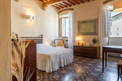 a hotel room with a bed and a piano at La casa della Guglia in Monte San Savino