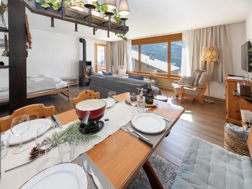 a living room with a table with plates on it at Apartment SnowKaya Grindelwald by Interhome in Grindelwald