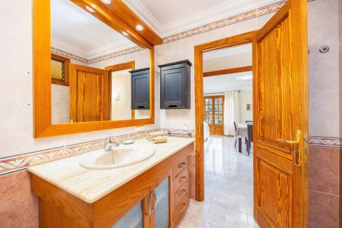 a bathroom with a sink and a mirror at Can Navarro in Port de Soller