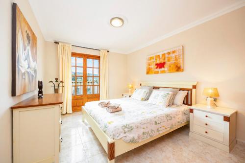 a bedroom with a large bed and a window at Can Navarro in Port de Soller