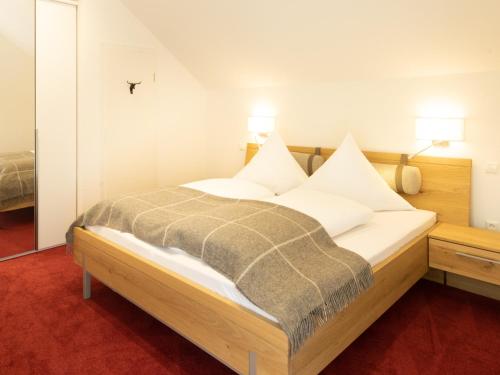 a bedroom with a bed with white pillows on it at Ferienwohnung Verschnuufeckli in Wehr