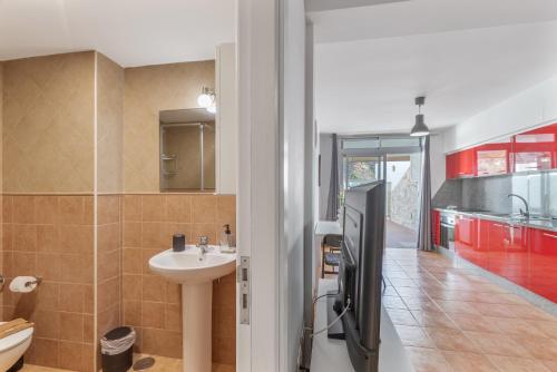 a bathroom with a sink and a toilet in a room at Vv Ancla in Puerto de Mogán