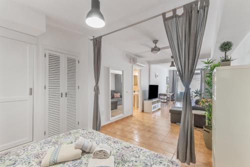 a bedroom with a bed and a living room at Vv Ancla in Puerto de Mogán