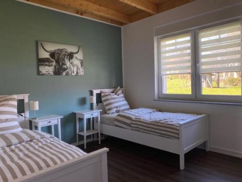 a bedroom with two beds and a window at Ferienhaus Marlen in Naumburg