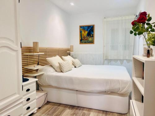 a bedroom with a white bed and a white dresser at Amets in Yesa