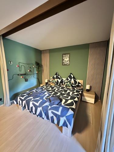 a bedroom with a bed with a blue and white comforter at Schwarzwald Martini in Sasbachwalden