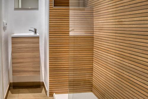 a bathroom with a shower with a sink at Old Side Duplex Platja d Aro in Platja d'Aro