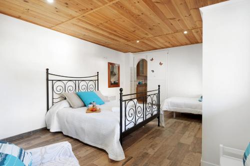 a bedroom with a black bed with a teddy bear on it at Casa Nene in La Matanza de Acentejo