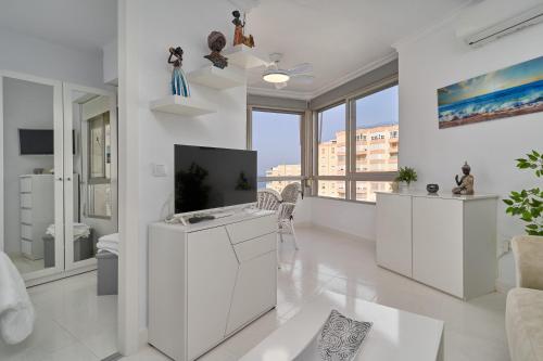 a living room with white furniture and a large window at Great views studio A84 in Torrox