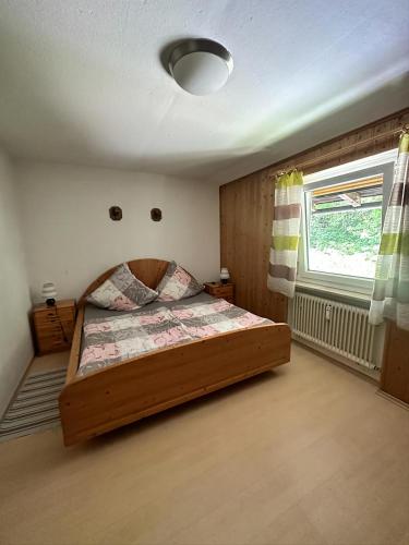 a bedroom with a wooden bed in a room at Haus Marianne in Bischofswiesen