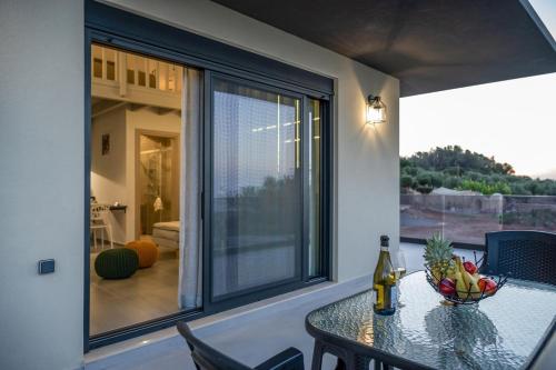 a balcony with a table with a bowl of fruit on it at Dias Guest House in Rethymno