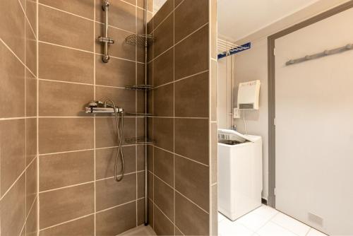 a bathroom with a shower stall with a toilet at Appartement T2 Les Pyrénées in Bagnères-de-Bigorre