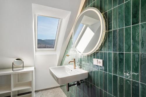 a bathroom with a sink and a mirror at Remise im Wolkensteiner Hof in Gernsbach