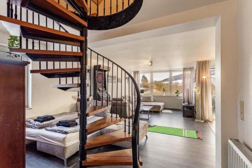 a spiral staircase in a room with a living room at Pistenblick in Willingen