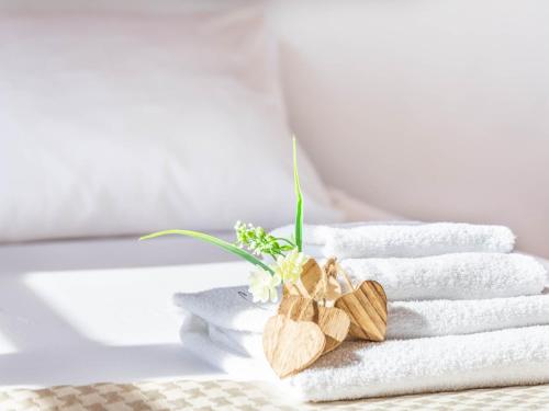 a bunch of towels with flowers on top of them at Palma Townhouse Near the Beach in Palma de Mallorca