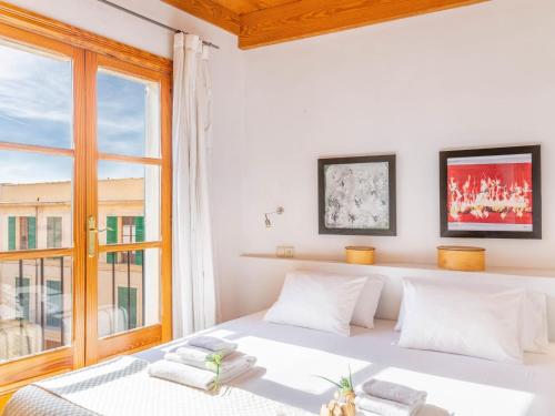 a bedroom with a white bed and a window at Palma Townhouse Near the Beach in Palma de Mallorca