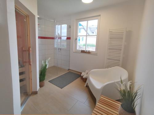 a bathroom with a shower and a toilet and a sink at Haus Elve in Zierow