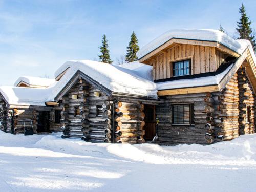 a log cabin with snow on top of it at Holiday Home Kantapää d3 by Interhome in Luosto