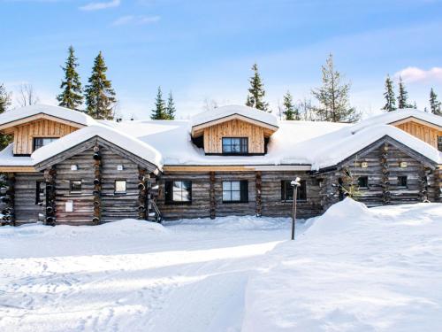 a log cabin with snow on the roof at Holiday Home Kantapää d3 by Interhome in Luosto