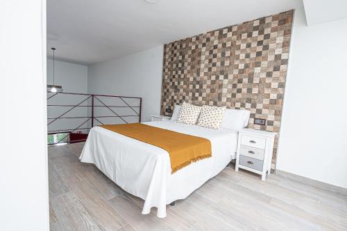 a bedroom with a bed and a brick wall at Ocean Suites A7 in Isla Cristina