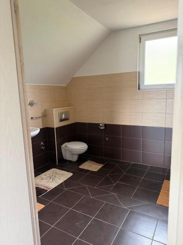 a bathroom with a toilet and a sink at Villa Rest Ilijas 4 bedrooms in Ilijaš