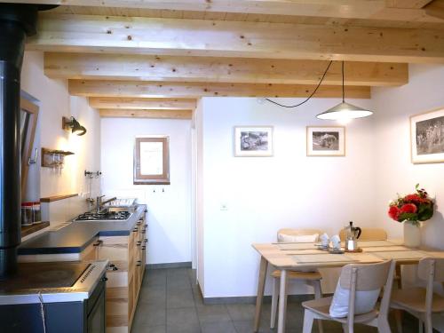 a kitchen with a table and a dining room at Holiday Home Rustico La Dimora by Interhome in Malvaglia