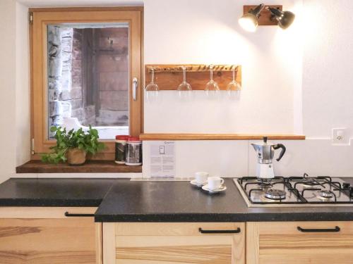a kitchen with a stove and a window at Holiday Home Rustico La Dimora by Interhome in Malvaglia