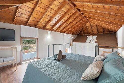 a bedroom with a blue bed and a tv at Casa La Plaza in El Paso