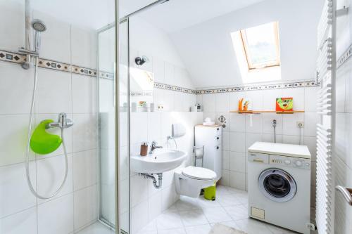 a bathroom with a toilet sink and a washing machine at Elstar in Stockach