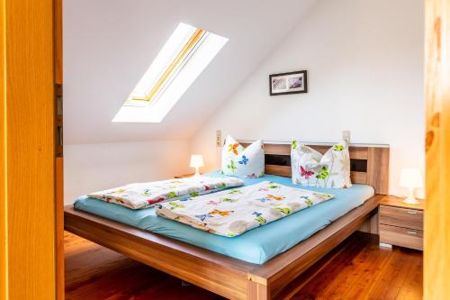 a bedroom with a bed and a skylight at Elstar in Stockach