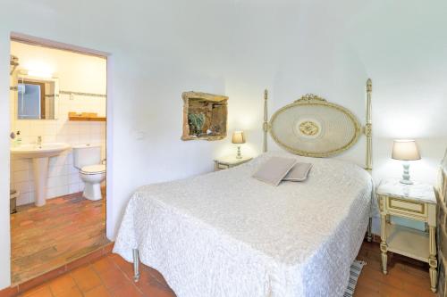 a bedroom with a bed with a book on it at Sesmarias Dos Nobres in Azinheira dos Barros