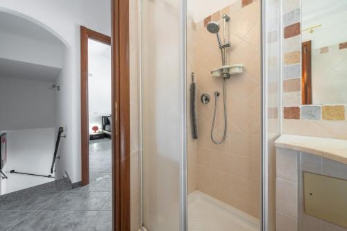 a shower with a glass door in a bathroom at Casa Annabella in Sarroch