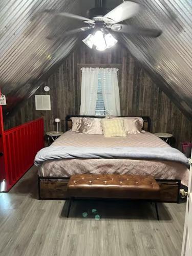 a bedroom with a bed with a ceiling fan at Prickly Pear - Rustic Cabin in New Braunfels