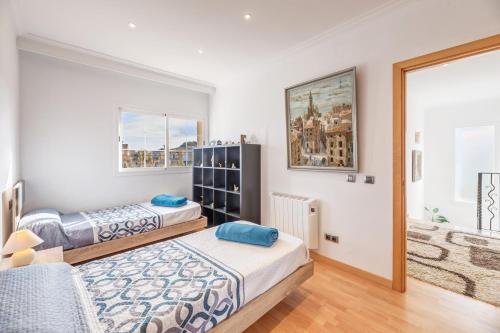 a bedroom with two beds and a window at Serra Fuster - Casa Tolleric in Llucmajor