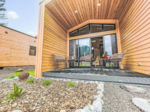 a house with a patio with chairs on it at Holiday Home Tiny-Haus Glockenalm-Alpenchalet Elli by Interhome in Aurach